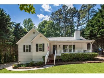 Charming one-story home with a covered front porch, a well-maintained lawn, and mature trees at 6637 Oak Farm Se Dr, Acworth, GA 30102