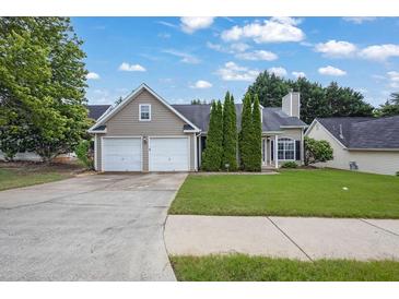 Charming single-Gathering home with a well-manicured lawn, two-car garage, and inviting curb appeal at 3020 Meadow Glen Pass, Fairburn, GA 30213
