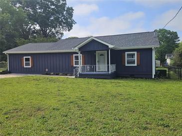 Charming single-story home featuring a well-manicured lawn and freshly painted exterior with decorative shutters at 775 Lee Andrews Se Ave, Atlanta, GA 30315