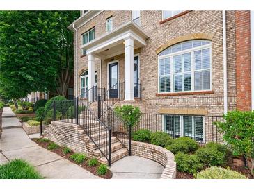 Charming brick townhouse with well-maintained landscaping and inviting front entrance at 359 Alderwood Ln, Atlanta, GA 30328