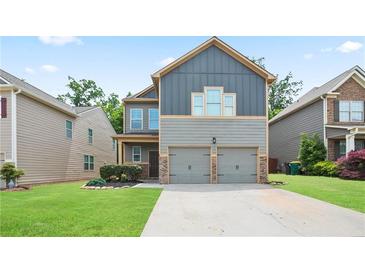 Charming two-story home with a two-car garage and well-maintained lawn in a suburban neighborhood at 4630 Roseman Trl, Cumming, GA 30040
