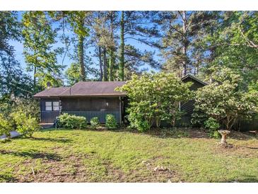 Charming single-story home with a lush, tree-filled yard, offering a serene and private setting at 161 Aaron Ct, Riverdale, GA 30274
