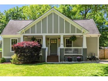 Charming craftsman-style home with well-manicured lawn and inviting front porch at 166 Martha Ave, Atlanta, GA 30317