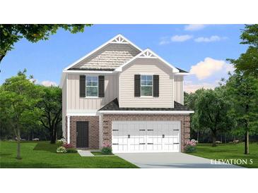 Charming two-story home featuring brick facade, attached two-car garage, and manicured lawn at 82 Hydrangea Cir, Fairburn, GA 30213