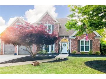 Charming two-story brick home featuring a manicured front yard, mature landscaping, and inviting curb appeal at 6505 Hampton Creek Dr, Cumming, GA 30041
