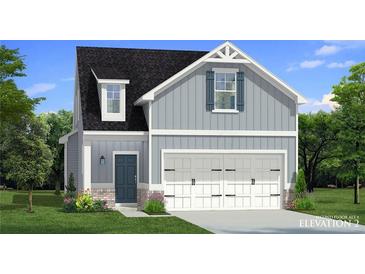 Charming two-story home with gray siding, a two-car garage, and a well-manicured front yard at 80 Hydrangea Cir, Fairburn, GA 30213