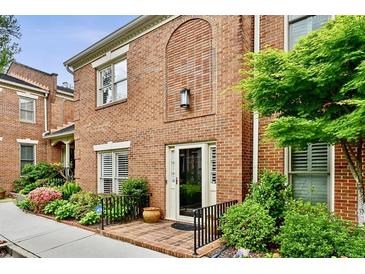 Charming brick home featuring manicured landscaping and a welcoming entrance at 505 Ansley Villa Dr, Atlanta, GA 30324