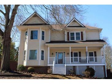 Charming two-story home with welcoming front porch and gable roof accents at 2031 Lakewood Cir, Grayson, GA 30017