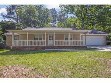 Charming single-story home with a covered front porch and well-maintained lawn at 1111 Louise Se Ct, Conyers, GA 30013