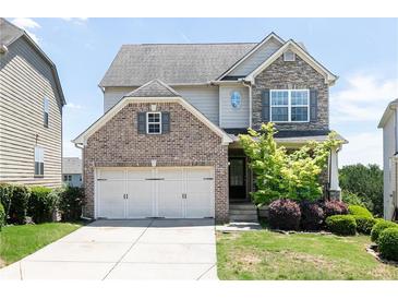 Charming two-story home featuring a brick and stone facade, a two-car garage, and a well-maintained lawn at 5888 Cobblestone Creek Cir, Mableton, GA 30126