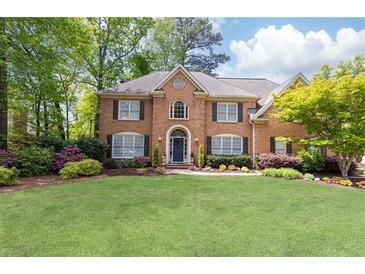 Charming brick home with a manicured lawn and mature trees, offering great curb appeal at 93 Ridgetree Ln, Marietta, GA 30068