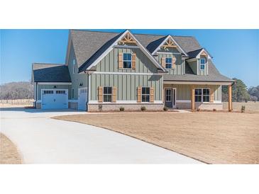Charming two-story home with a manicured lawn, a two car garage, and a covered porch at 257 Pinewood Dr, Covington, GA 30014