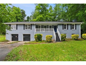 Charming single-story home with a well-maintained lawn and front-facing two-car garage at 6549 Biscayne Way, Douglasville, GA 30135