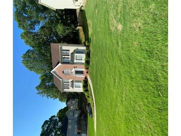 Charming two-story home with lush green lawn and mature trees in a desirable neighborhood at 665 Somerset Vale Dr, Lawrenceville, GA 30044