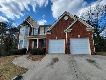 Charming two-story home with a brick and siding exterior and a two-car garage at 1745 Collines Sw Ave, Atlanta, GA 30331