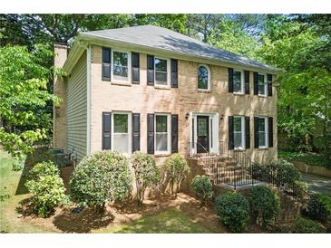 Charming two-story brick home with black shutters and landscaped front yard at 2068 Signal Ridge Nw, Kennesaw, GA 30152