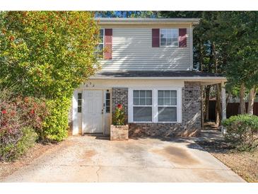 Charming two-story home featuring brick accents, neutral siding and red shutters at 3652 Platina Park Ct, Decatur, GA 30034