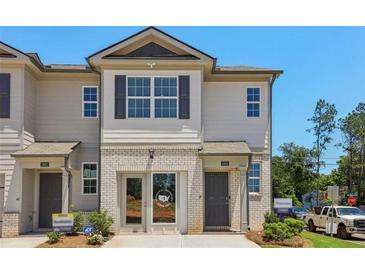 Charming townhome with brick accents, neutral siding, and well-manicured landscaping at 2362 Haran Dr # 35, Lithonia, GA 30058