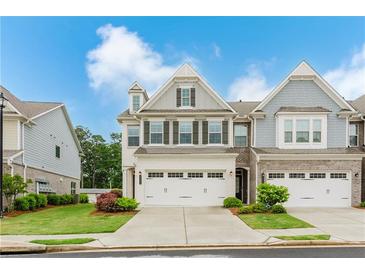 Charming two-story townhome with a well-manicured lawn and two-car garage for convenient parking at 2089 Lanier Harbor Pt # 2089, Buford, GA 30518