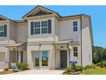 Charming two-story townhouse with a mix of siding and brick, landscaped front yard, and a welcoming entrance at 2364 Haran Dr # 35, Lithonia, GA 30058