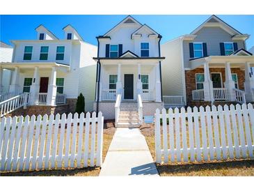 Charming two-story home with white picket fence and inviting front porch, perfect curb appeal at 458 Bishop Ln, Woodstock, GA 30188