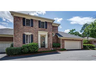 Charming brick home with black shutters, elegant entrance, and attached two-car garage at 609 Pinetree Dr, Decatur, GA 30030