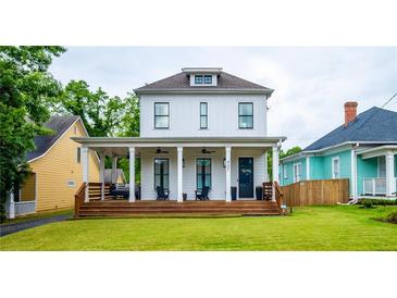 Charming white two-story home with a welcoming front porch and well-manicured lawn at 437 E Ontario Sw Ave, Atlanta, GA 30310