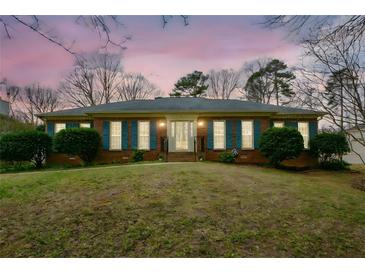 Charming brick home with blue shutters and manicured landscaping at 118 Heritage Way, Peachtree City, GA 30269
