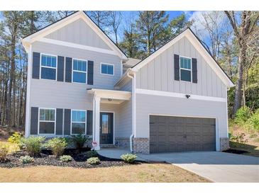 Two-story home with gray siding, dark shutters, and a two-car garage at 2099 Easterwood Ter, Decatur, GA 30032