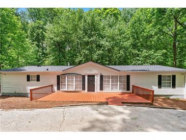 Charming one-story home with a large wooden deck, perfect for relaxing outdoors at 6670 George Ct, Cumming, GA 30041