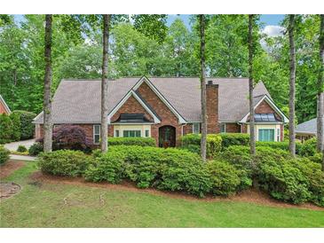Charming brick home with lush landscaping and mature trees offering great curb appeal at 3456 Drayton Ne Dr, Roswell, GA 30075
