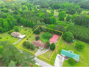 Expansive property featuring multiple structures and lush greenery, offering both space and privacy at 95 Stephens Dr, Covington, GA 30016