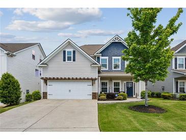 Charming two-story home with a well-manicured lawn and a welcoming front porch at 2624 Chase Rdg, Kennesaw, GA 30144