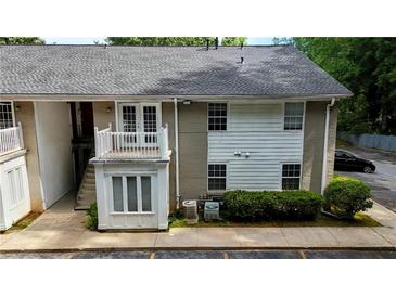 Two-story condo with small deck and stairs on a sunny day at 1212 Utoy Springs Rd # 46, Atlanta, GA 30331