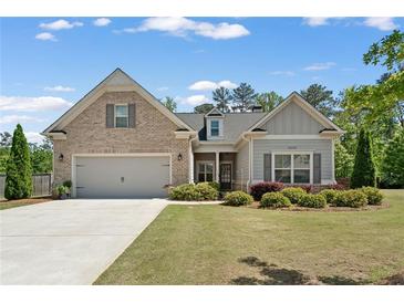 Charming home with a well-maintained lawn, a two-car garage, and a mix of brick and siding exterior at 3219 Blackshear Dr, Marietta, GA 30060
