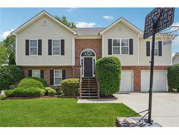 Charming two-story home with brick and siding, arched front door, manicured lawn, and a basketball hoop at 3123 Morgan Box Ln, Buford, GA 30519