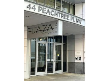 Modern condo building entrance with the building name in large silver lettering at 44 Peachtree Nw Pl # 1728, Atlanta, GA 30309