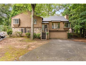 Charming two-story home with stone accents, mature trees, and a spacious driveway at 1359 Cedar Park Pl, Stone Mountain, GA 30083