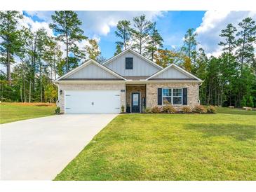 Charming single-story home with a well-maintained lawn, brick accents, and a welcoming front entrance at 426 Samara Ct, Fairburn, GA 30213