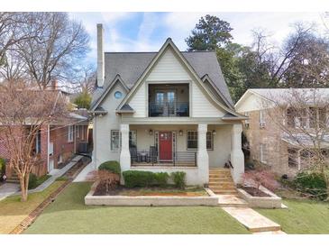 Charming two-story home with landscaped front yard, inviting porch and balcony at 101 Terrace Dr, Atlanta, GA 30305