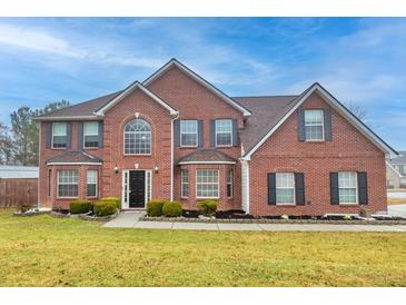 Beautiful two-story brick home with manicured lawn and traditional architectural details at 1439 Alice Ave, Lithonia, GA 30058