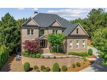 Beautiful brick home with manicured landscaping and a welcoming front entrance at 8745 Islesworth Ct, Duluth, GA 30097