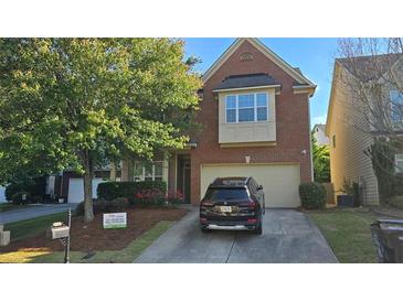 Charming brick two-story home with a two-car garage, a well-maintained lawn, and a driveway for extra parking at 2275 Copper Trail Ln, Buford, GA 30519