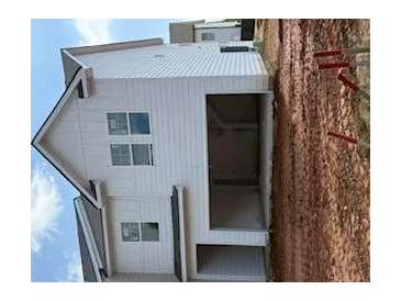 Modern two-story home featuring a white exterior, a covered entry, and a spacious two-car garage at 1031 Merritt Dr # 96, Villa Rica, GA 30180