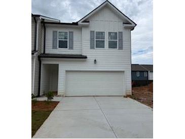 Charming two-story home with a two-car garage, white siding, gray shutters, and concrete driveway at 1031 Merritt Dr # 96, Villa Rica, GA 30180