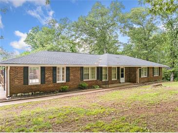 Charming brick home with black shutters, a covered entry, and a lush green lawn at 9 Latimer Rd, Cartersville, GA 30121