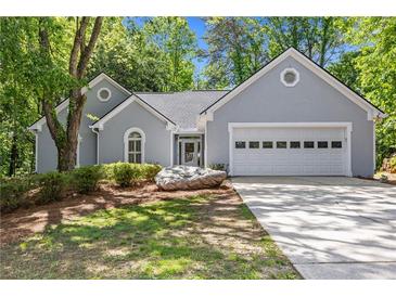 Charming one-story home with a two-car garage, inviting curb appeal, and well-maintained landscaping at 1965 Tiner Ct, Cumming, GA 30041