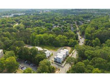 An aerial view of modern townhomes surrounded by lush greenery and a well-maintained parking area at 2202 Carlton Ct # 7, Atlanta, GA 30318
