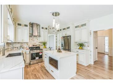 Bright kitchen with stainless steel appliances, white cabinets, and quartz countertops at 1095 Lyndhurst Way, Roswell, GA 30075