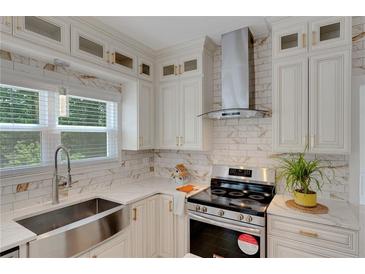 Bright kitchen features white cabinetry, stainless steel appliances, and a modern design at 1095 Lyndhurst Way, Roswell, GA 30075
